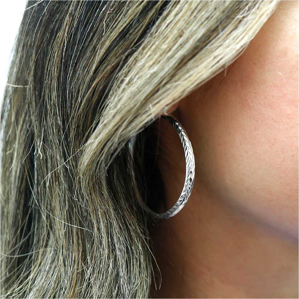 Silver Sterling Silver Etched Diamond Cut Bangle Hoops On Ear